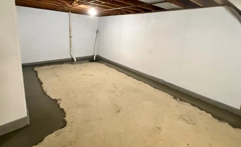 Standing water collected along a concrete interior wall before extraction and structural drying Standing water collected along a concrete interior wall before extraction and structural drying