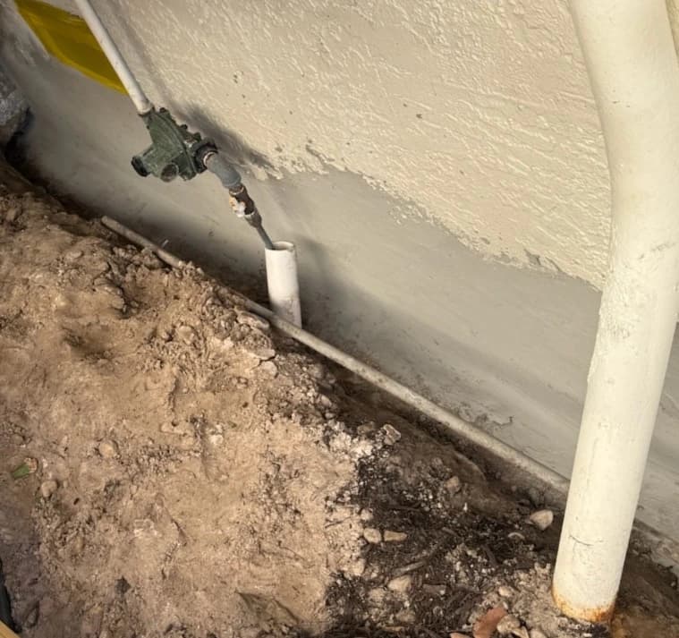 Excavated foundation edge showing a repaired waterproofed seam at a Florida home Excavated foundation edge showing a repaired waterproofed seam at a Florida home