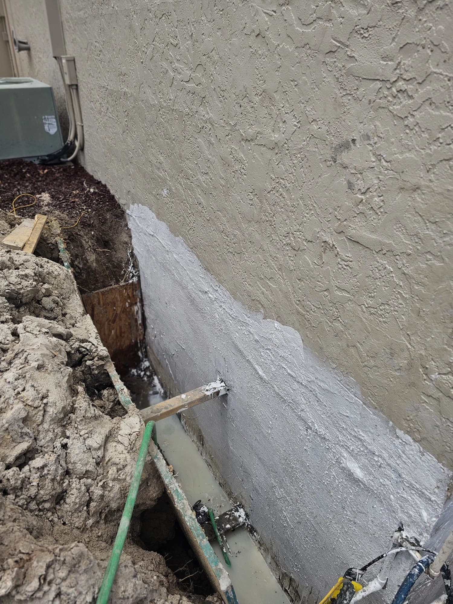 Waterproofing membrane applied along an excavated Florida block foundation Waterproofing membrane applied along an excavated Florida block foundation