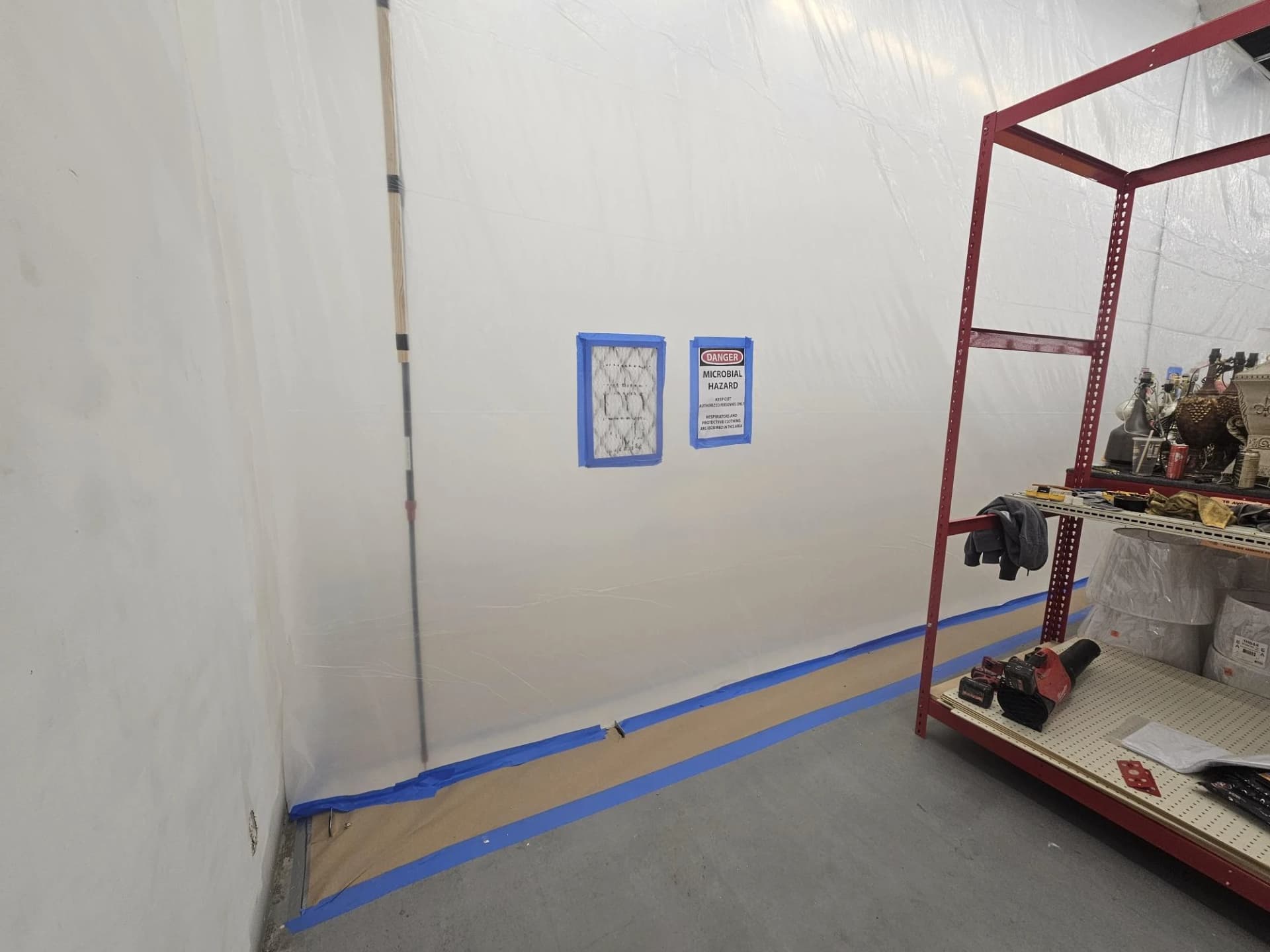 Interior work area isolated with protective sheeting during water intrusion repairs Interior work area isolated with protective sheeting during water intrusion repairs