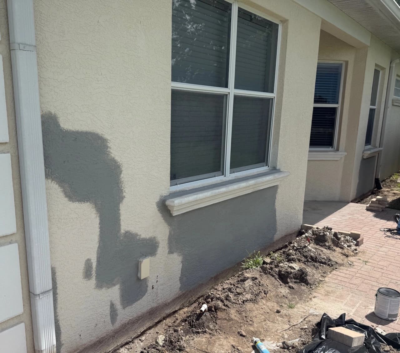 Exterior block wall under inspection after localized moisture damage near a Florida window Exterior block wall under inspection after localized moisture damage near a Florida window