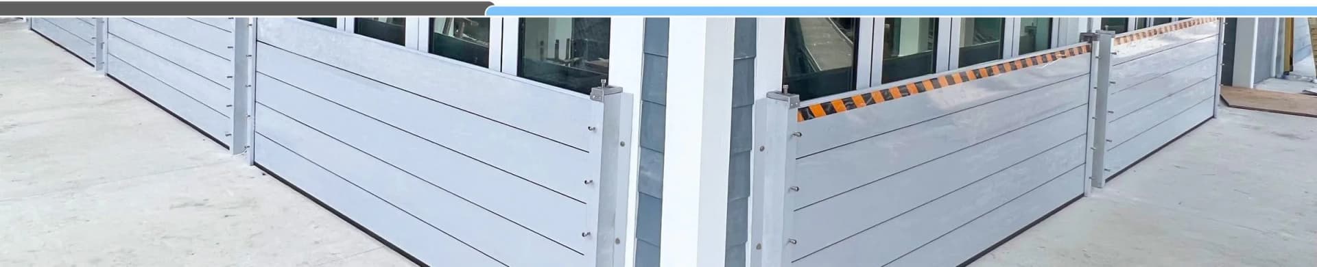 Garrison Hammerhead aluminum flood planks stacked in channel posts across a garage opening