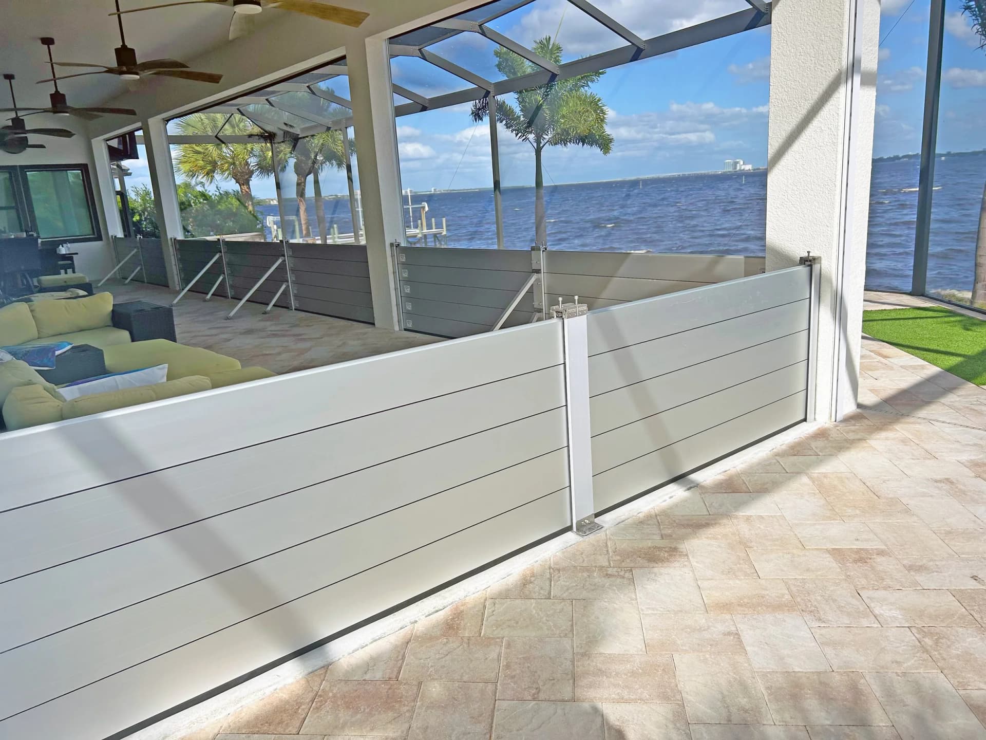 Aluminum Garrison flood barrier planks locked across a home's doorway holding back floodwater Aluminum Garrison flood barrier planks locked across a home's doorway holding back floodwater