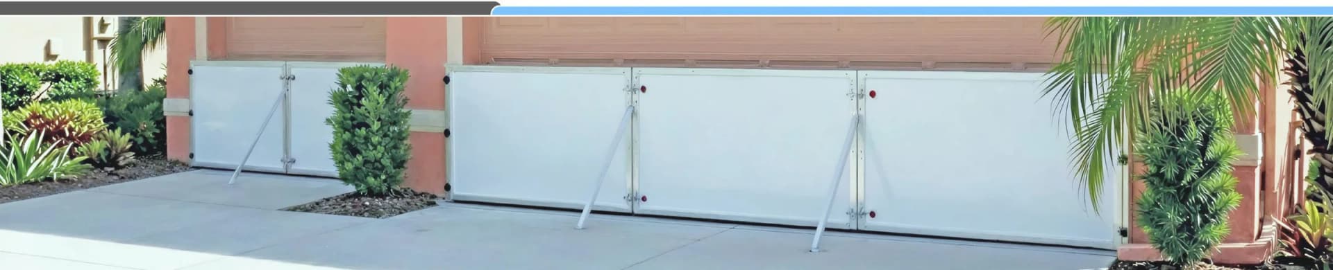 Garrison YellowFIN flood barrier panels mounted directly across a home's opening without vertical posts